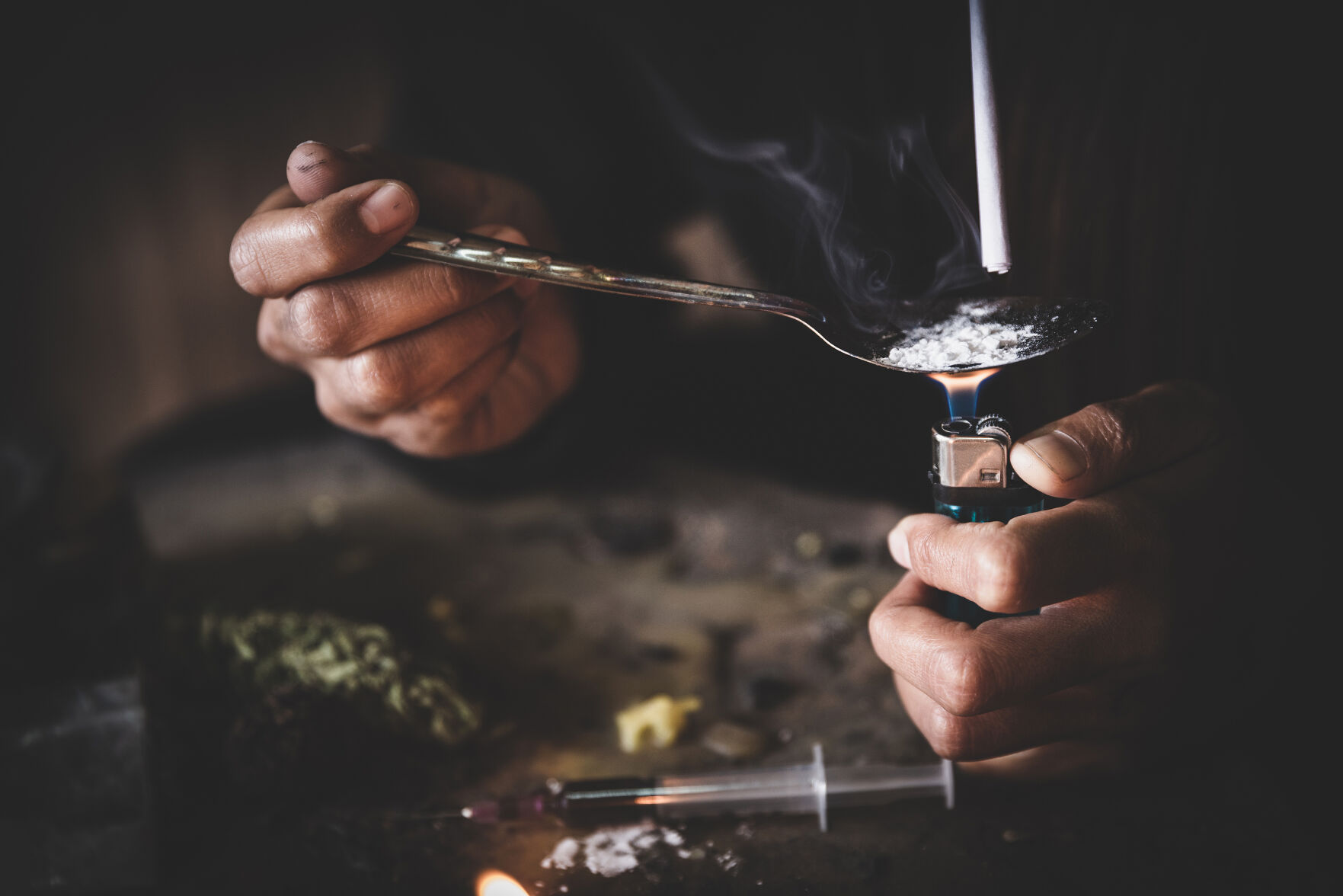 Drug Addicts In The Dark Room. Addict/junkie Preparing Drugs With A Spoon And Lighter. White Powder